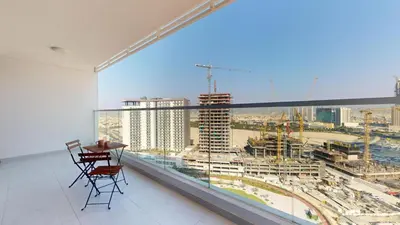 a balcony with a table and chairs and a large window at Vacationer l Elegant 1 Bedroom l Arjan l Pool with View Deck in Dubai