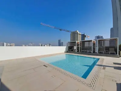 a swimming pool on the roof of a building at Vacationer l Contemporary 1 Bed l City Views l near Circle Mall in Dubai