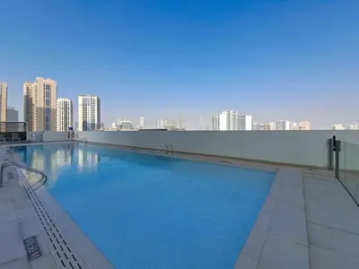 a large swimming pool on the roof of a building at Vacationer l Contemporary 1 Bed l City Views l near Circle Mall in Dubai