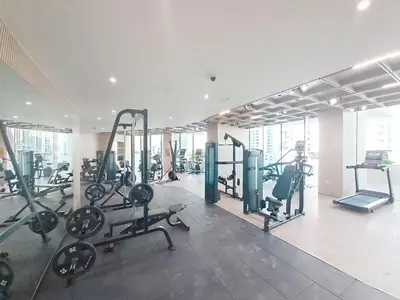 a gym with treadmills and machines in a building at Vacationer l Modern 1 Bed l Private Pool l Community Views in Dubai