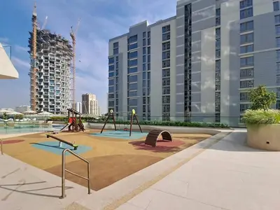 a playground in front of a large building at Vacationer l Modern 1 Bed l Private Pool l Community Views in Dubai