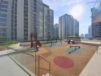 a playground with swings and benches on a rooftop at Vacationer l Modern 1 Bed l Private Pool l Community Views in Dubai
