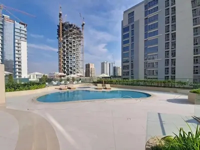 a pool in the middle of a city with tall buildings at Vacationer l Modern 1 Bed l Private Pool l Community Views in Dubai