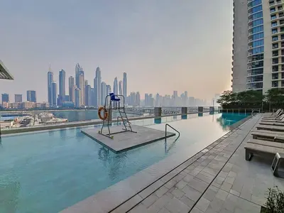 a swimming pool with a statue in the middle of a city at Vacationer l Classic 2 Bedroom l Marina Views l Private Beach in Dubai