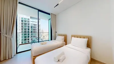 two beds in a room with a large window at Vacationer l Classy 2 Bedroom l Private Jacuzzi l near Circle Mall in Dubai