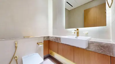 a bathroom with a sink and a mirror at Vacationer l Classy 2 Bedroom l Private Jacuzzi l near Circle Mall in Dubai