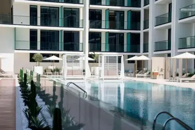 a large building with a large swimming pool at Vacationer l Classy 2 Bedroom l Private Jacuzzi l near Circle Mall in Dubai