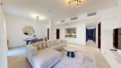 a living room with a white couch and a table at Vacationer l Upgraded Modern 2 Bed l Downtown l Near Dubai Mall in Dubai