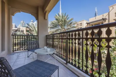 a balcony with a table and chairs and a view of the city at Vacationer l Upgraded Modern 2 Bed l Downtown l Near Dubai Mall in Dubai