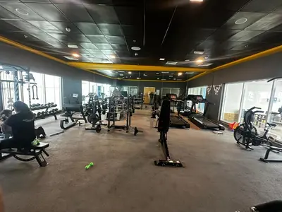 a gym with lots of treadmills and exercise bikes at Spacious 1 Bedroom Apartment-Opal Tower Dubai Marina in Dubai