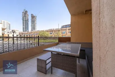 a balcony with a table and a view of a city at Modern 1BR Apartment in JVC Pool Gym Near Circle Mall in Dubai