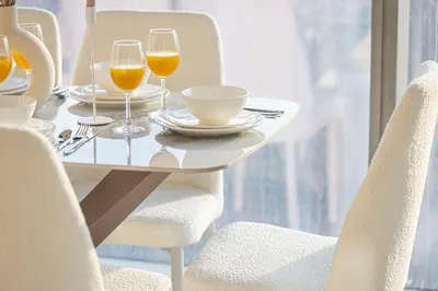 a table with two glasses of wine on it at Highest Infinity Pool - Paramount Midtown Hotel & Luxury Apartments Burj Khalifa view & Partial Fountain View in Dubai