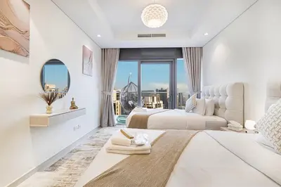 a bedroom with two beds and a large window at Highest Infinity Pool - Paramount Midtown Hotel & Luxury Apartments Burj Khalifa view & Partial Fountain View in Dubai