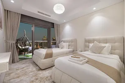 a hotel room with two beds and a couch at Highest Infinity Pool - Paramount Midtown Hotel & Luxury Apartments Burj Khalifa view & Partial Fountain View in Dubai