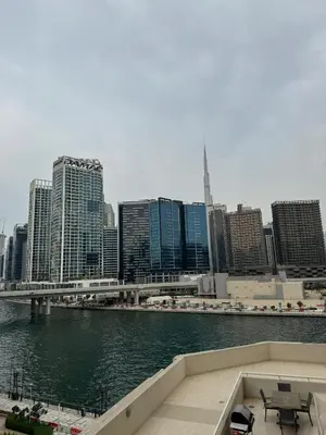 a view of a city with a river and buildings at Burj Khalifa & Canal View Apartment in Dubai