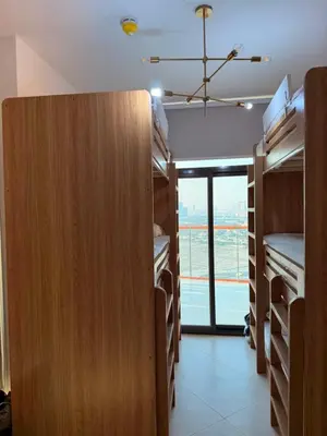 a room with wooden bunk beds and a large window at Magra CHILL SPOT HOSTEL in Sabkhah