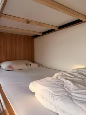two beds in a room with white sheets at Magra CHILL SPOT HOSTEL in Sabkhah