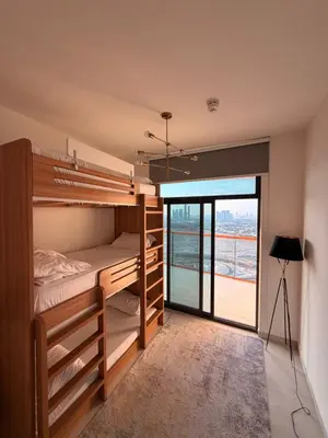 a room with bunk beds with a view of the ocean at Magra CHILL SPOT HOSTEL in Sabkhah