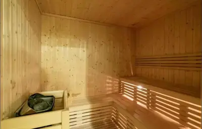 an empty wooden sauna with a bench in it at Luxury 2BR Downtown Apartment - Canal & City Views in Dubai
