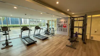 a gym with several tread machines in a room at Charming & Cozy 1BR Burj Khalifa Skyline View in Dubai