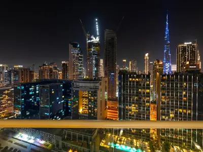 a view of a city skyline at night at Charming & Cozy 1BR Burj Khalifa Skyline View in Dubai