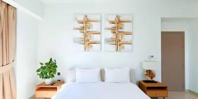 a bedroom with a white bed and wooden shelves at Luxury in Dubai 2 bedroom apartment with balcony in Dubai