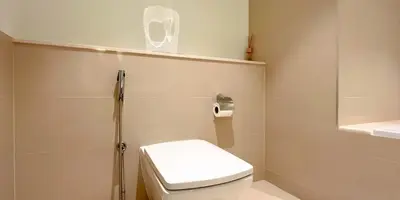 a white bathroom with a toilet and a shower at Luxury in Dubai 2 bedroom apartment with balcony in Dubai