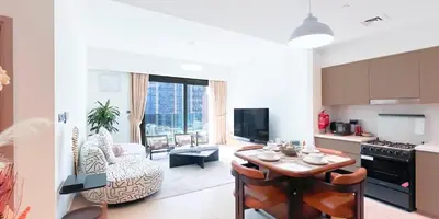 a kitchen and a living room with a table in a room at Luxury in Dubai 2 bedroom apartment with balcony in Dubai