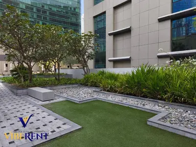 a garden with grass in front of a building at Business Bay Retreat,Views & Vibes,10 min to Burj in Dubai