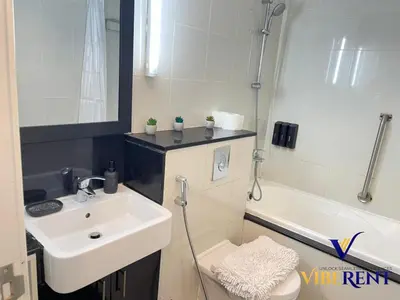 a bathroom with a sink and a toilet and a tub at Business Bay Retreat,Views & Vibes,10 min to Burj in Dubai