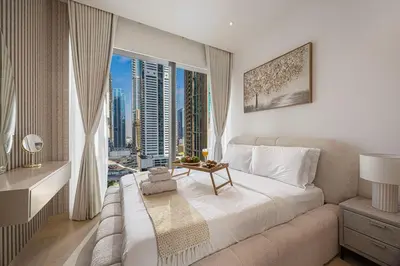 a bedroom with a large bed and a large window at Livin' Holidays - 1 BR - Paradise getaway Dubai Marina in Dubai