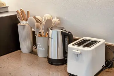 a kitchen counter with a coffee maker and utensils at Livin' Holidays - 1 BR - Paradise getaway Dubai Marina in Dubai