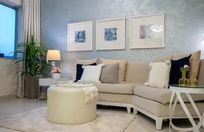 a living room with a couch and a table at Damac Maison Downtown Dubai Luxury 1BR Walk to Dubai Mall in Dubai