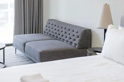 a bedroom with a bed and a chair and a couch at Modern Studio in Business Bay in Dubai