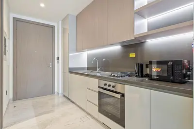 a kitchen with a sink and a stove top oven at Modern Studio in Business Bay in Dubai