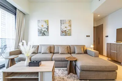 a living room with a couch and a table at Luxury 1BR Downtown, Pool, Gym, Opera District in Dubai