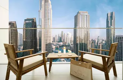 a table and chairs on a balcony with a view of a city at the space in Dubai