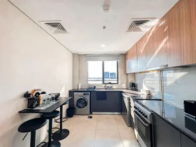 a large kitchen with a sink and a dishwasher at Stunning 1 Bed Large Luxury Apt with Pool View Al Barari by Luxaura in Dubai