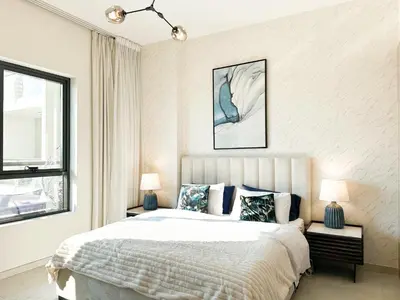a bedroom with a bed and two lamps and a window at Stunning 1 Bed Large Luxury Apt with Pool View Al Barari by Luxaura in Dubai