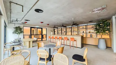 a restaurant with tables and chairs in a room at HAVN - Cozy 1 bedroom in Golfville in Dubai