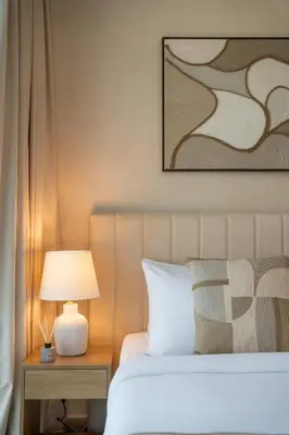 a bedroom with a bed and a table with a lamp at Airstay - Bright Top-Floor 1BR - Azizi Riviera 8 - Monthly Offer Available! in Dubai