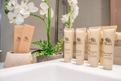 a row of bamboo products on a table with flowers at Airstay - Bright Top-Floor 1BR - Azizi Riviera 8 - Monthly Offer Available! in Dubai