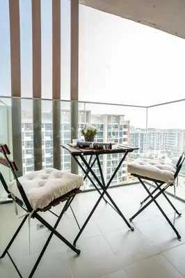 a table and two chairs in a room with a window at Airstay - Bright Top-Floor 1BR - Azizi Riviera 8 - Monthly Offer Available! in Dubai