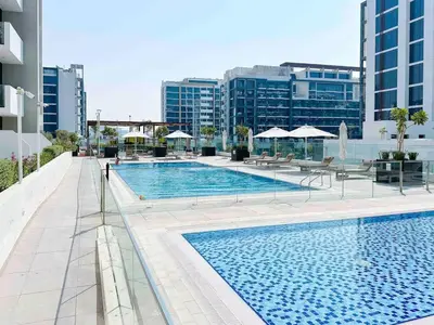 a large swimming pool on top of a building at Airstay - Bright Top-Floor 1BR - Azizi Riviera 8 - Monthly Offer Available! in Dubai