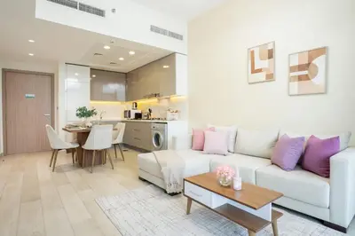 a living room with a white couch and a table at Airstay - Bright Top-Floor 1BR - Azizi Riviera 8 - Monthly Offer Available! in Dubai