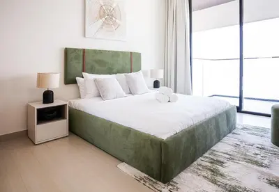 a bedroom with a large bed with a large window at Modern 1 Bed Apartment in Binghatti Orchid in Dubai