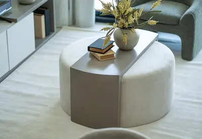 a coffee table with books and a vase on top at Modern 1 Bed Apartment in Binghatti Orchid in Dubai