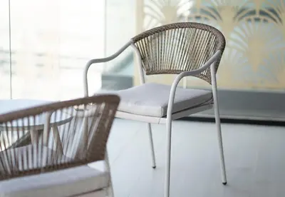 a chair sitting next to a table in a room at Modern 1 Bed Apartment in Binghatti Orchid in Dubai