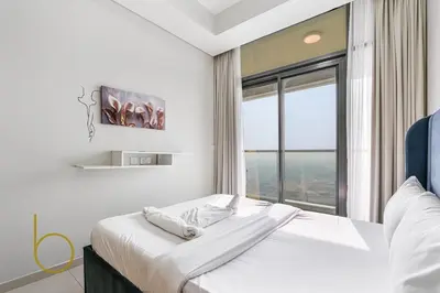a bedroom with a large bed with a large window at Bookable 1 Bed Aykon City with Amazing Bird eye view in Dubai