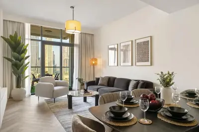 a living room with a couch and a table at Elegant 3 BR - Stunning Burj Khalifa Views in Dubai